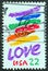 USA - CIRCA 1985: A stamp printed in USA shows a brilliant rainbow painted on a natural gas tank by Corita Kent