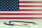 USA flag on the background of tablets, stethoscope and medical syringe on the table. American flag and medical supplies