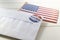 USA flag and Envelope containing voting ballot papers being sent by mail for absentee vote in presidential election