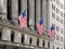 Usa flags waving in Financial District Wall Street Manhattan New York City