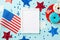 USA Independence Day concept. Top view photo of photo frame star garland national flags confetti and plate with glazed donuts on