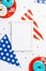 USA Independence Day concept. Top view vertical photo of photo frame national flag garland plates with glazed donuts and confetti