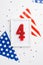 USA Independence Day concept. Top view vertical photo of photo frame with number 4 candle national flag garland and confetti on