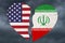 USA and Iran flags in a broken heart