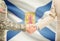 USA military man in uniform and civil man in suit shaking hands with certain Canadian province flag on background - Nova Scotia