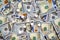 USA national currency, top view of mixed American dollars banknotes with white pills on it, drugs