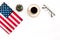 USA national day background with flag, glasses and cup of coffee on white desk top view copy space