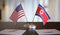 USA and North Korean flags on table. Negotiation between North Korea and United states. 3D rendered illustration.