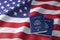 USA passport on the flag of the US United Stetes. Getting a USA passport, naturalization and immigration concept