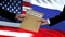 USA and Russia officials exchanging confidential envelope, flags background