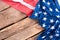 USA satin flag on old wooden boards.