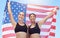 USA winner flag, women in sports and runner on podium at marathon event, team celebration at professional game and smile