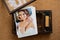 USB flash drive and a printed copy of the wedding photos in a wooden box.