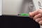 USB Green flash memory connected by hand to a monitor