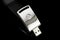 USB metal flash drive on black background. Silver color memory s