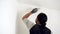 Use of the brush for home renovation. renovate the walls of the home. man applying paint to a wall.