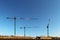 Use of high tower frame metal cranes in construction. Panorama of the development of the city against the blue sky. Work in real