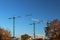 Use of high tower frame metal cranes in construction. Panorama of the development of the city against the blue sky. Work in real e