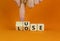 Use or lose symbol. Concept words Use or lose on wooden cubes. Businessman hand. Beautiful orange table orange background.