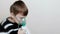 Use nebulizer and inhaler for the treatment. Boy inhaling through inhaler mask. Side view.