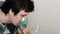 Use nebulizer and inhaler for the treatment. Young man inhaling through inhaler mask. Side view.