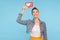 Use network Like button! Portrait of happy fashionably dressed woman with hair bun holding social media heart icon over head