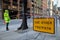 Use other footpath traffic warning sign barrier applying on busy street downtown on pedestrian footpath