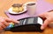 Use payment terminal for paying for cheesecake and coffee in cafe, finance concept