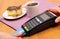 Use payment terminal for paying for cheesecake and coffee in cafe, finance concept