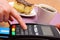 Use payment terminal for paying for cheesecake and coffee in cafe, finance concept