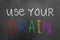 Use your brain chalk text on blackboard or chalkboard