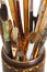 Used artistic paintbrushes in wooden cup closed up