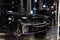 Used black car Land Rover Range Rover disassembled without bumper and wheels on a four-post lift for repairing the chassis and