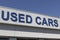 Used Car sign at a pre-owned car dealership. As supplies of new cars dwindle, used cars become more popular