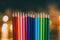 Used color pencils lined up with fairy lights bokeh in the background