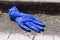 Used and disposed purple surgical gloves lying in the street