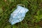 Used face surgical mask dumped on the ground during the Covid-19 pandemic.