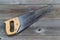 Used Hand Saw on Rustic Wood
