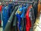 Used jackets in row on local second hand shop.