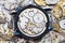 Used mechanical wristwatch on heap of spare parts