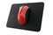 Used metal red gaming mouse with scratches on professional pad isolated on white