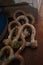 Used and rusty stained lifting shackles lying on a floor in a dirty container with lashing and lifting equipment onboard of a ship