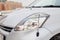 Used silver Toyota Passo with an engine of 1.3 liters front headlight with parking antenna view on the car snow parking after