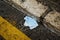 Used surgical mask thrown on the asphalt