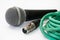 Used vocal microphone with old green xlr cable on the white back