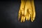 Used yellow rubber gloves on a black background