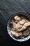 Useful barley porridge in a bowl on a gray stone