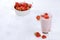 Useful breakfast, food for children, strawberry yogurt, smoothies and granola on a bright table. The concept of healthy and