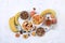 Useful breakfast with ingredients, place for text, fruit salad with granola, apricots, bananas, honey and peaches on a bright