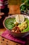 Useful Italian vegan food. Vegetarian bowl for breakfast of porridge couscous, avocado, cucumber, Brussels sprouts and vegetable